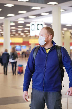 European redbeard man is in protective medical mask in airportのeditorial素材