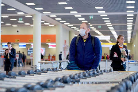 European redbeard man is in protective medical mask in airportのeditorial素材