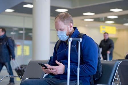 European redbeard man is in protective medical mask in airportのeditorial素材
