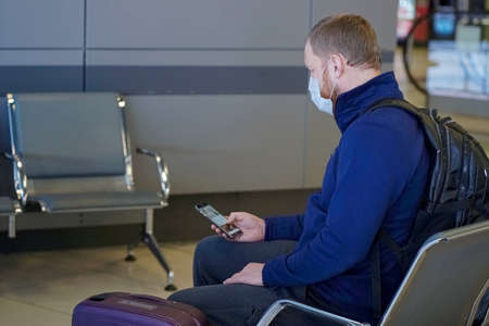 European redbeard man is in protective medical mask in airportのeditorial素材