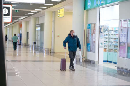 European redbeard man is in protective medical mask in airportのeditorial素材
