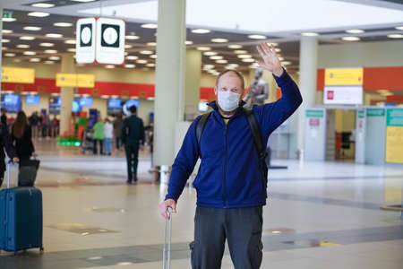 European redbeard man is in protective medical mask in airportのeditorial素材