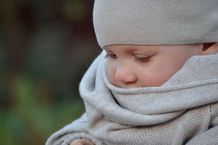 The girl is crying, you can see the teardrop on her cheek. High quality photo