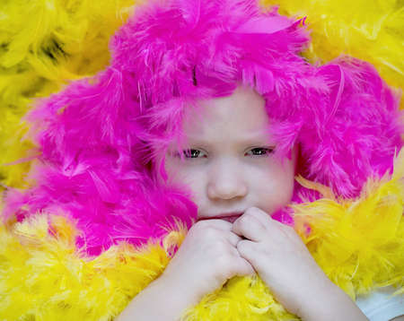 little girl lies in a blurred festive setting. Birthday, holiday.の写真素材