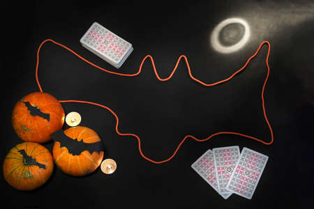 Blurred Halloween concept. Pumpkins, bats, candles, cards on a black background. ... High quality photoのeditorial素材