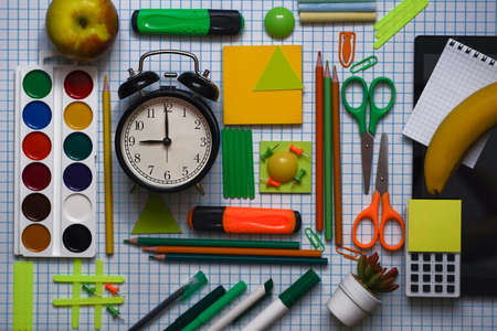 Blurred background of Back To School concept Alarm Clock Blackboard Pencil Stationery on Black Background. Top View Flat Lay, vertical. High quality photoの写真素材