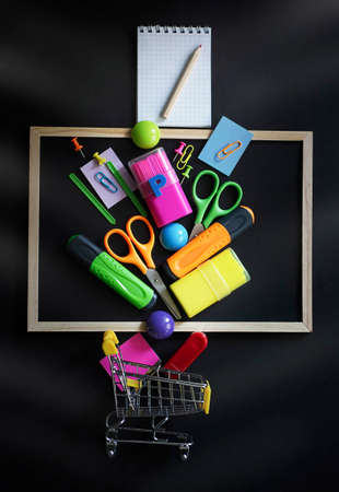 Blurred background of Back To School concept Alarm Clock Blackboard Pencil Stationery on Black Background. Top View Flat Lay, vertical. High quality photoの写真素材
