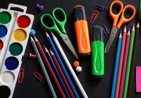 Blurred background of Back To School concept Alarm Clock Blackboard Pencil Stationery on Black Background. Top View Flat Lay, vertical. High quality photoの写真素材