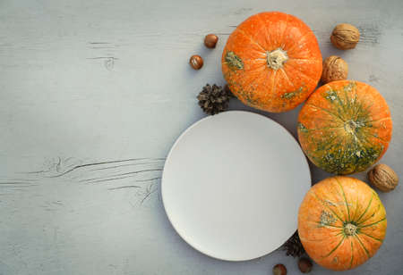 Blurred Fresh pumpkins with empty plate on Wooden Background with Copy Space. High quality photoの写真素材