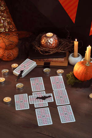 Defocused mystic ritual with tarot cards, and candles. Helloween concept, black magic or fortune telling rite with occult and esoteric symbols. ... High quality photoのeditorial素材