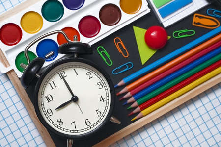 Blurred background of Back To School concept Alarm Clock Blackboard Pencil Stationery on Black...