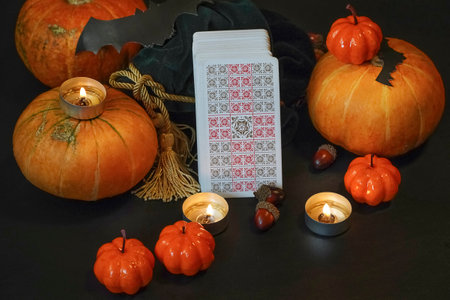 Defocused mystic ritual with tarot cards, and candles. Halloween concept, black magic or fortune telling rite with occult and esoteric symbols. ... High quality photoのeditorial素材