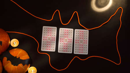 Blurred Halloween concept. Pumpkins, bats, candles, cards on a black background. ... High quality photoのeditorial素材