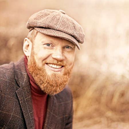 Close up portrait of handsome man with beard smiling outside. High quality photoの写真素材