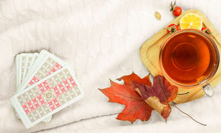 Autumn comAutumn composition with cup of tea maple leaves and tarot cards position with cup of tea...