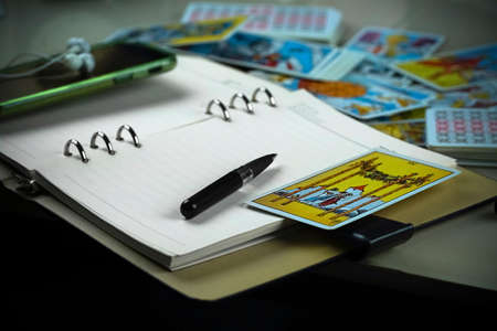 Moscow / Russia - October 2020: Blurred still life with Tarot cards layout on witch table. Esoteric concept and astrology.のeditorial素材
