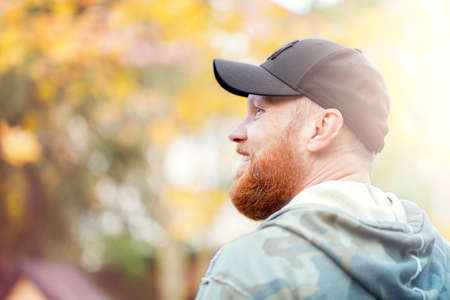 Man with red beard on blurred autumn background. High quality photo
