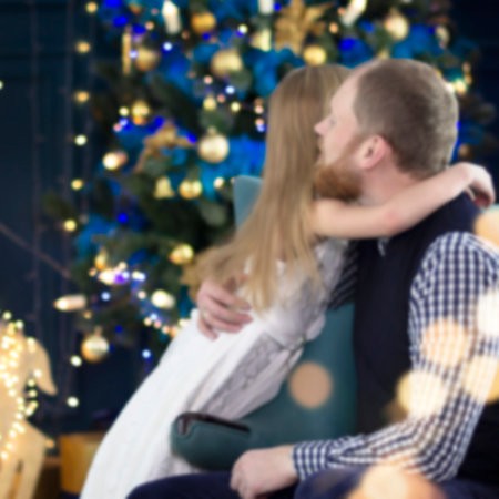 Blurred background of Father hugs daughter against the background of christmas scenery. High quality photoの写真素材