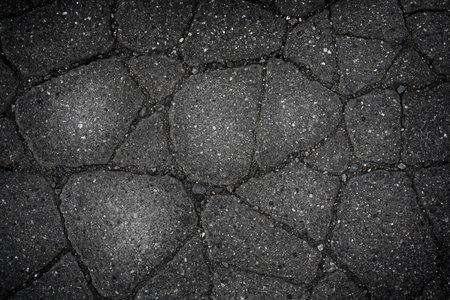 abstract gray backgroabstract gray background of cracked asphaltund of cracked asphalt. High quality...