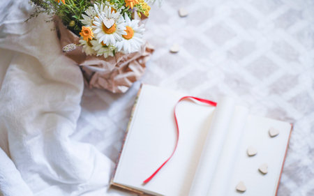 Valentine's Day vertical background with bouquet of wild flowers, notebook and red hearts. Valentines day concept. ... High quality photoの写真素材