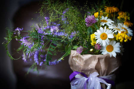 Background with blurred bouquet of wild flowers on dark. High quality photoの写真素材