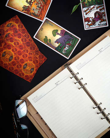 Illustrative Editorial. Tarot cards and esoteric concept. Magic rituals. Mystical table with...
