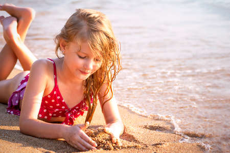 7 years girl sunbathing on the seashore. Summer concept. Selective Focusの写真素材