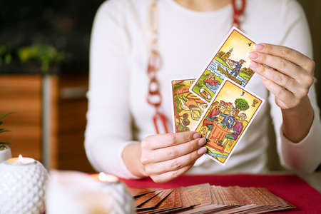 Blurred fortune teller of hands holding tarot cards. Forecasting concept. High quality photoのeditorial素材