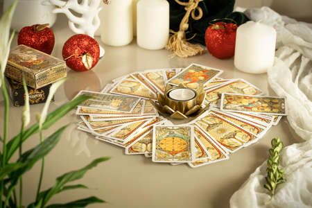 Defocused mystic ritual with tarot cards, and candles. Halloween concept, black magic or fortune telling rite with occult and esoteric symbols.のeditorial素材