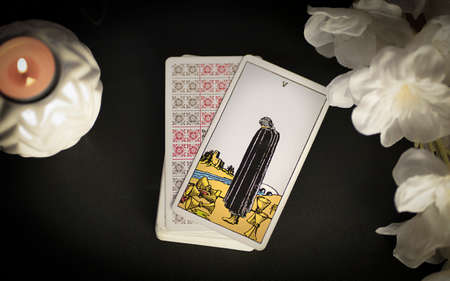 View of tarot card on the table under candlelight, 5 of cups. High quality photo