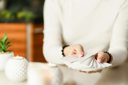 Selective Focus of two hands shuffling and adjusting tarot cards. High quality photoのeditorial素材