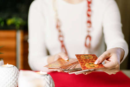 Selective Focus of two hands shuffling and adjusting tarot cards. High quality photoのeditorial素材