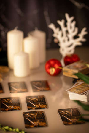 Defocused mystic ritual with tarot cards, and candles. Halloween concept, black magic or fortune telling rite with occult and esoteric symbols.のeditorial素材