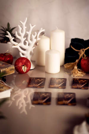 Defocused mystic ritual with tarot cards, and candles. Halloween concept, black magic or fortune telling rite with occult and esoteric symbols.のeditorial素材