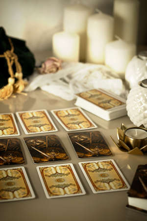 Defocused mystic ritual with tarot cards, and candles. Halloween concept, black magic or fortune telling rite with occult and esoteric symbols.のeditorial素材