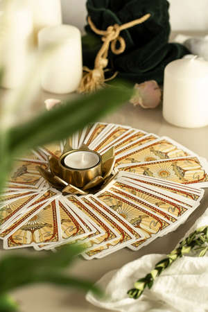Defocused mystic ritual with tarot cards, and candles. Halloween concept, black magic or fortune telling rite with occult and esoteric symbols.のeditorial素材