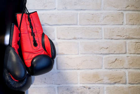Boxing gloves black with orange on a brick wall background. Sport Concept. High quality photo