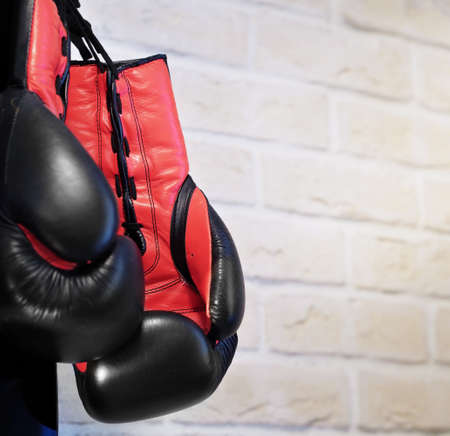 Boxing gloves black with orange on a brick wall background. Sport Concept. High quality photo