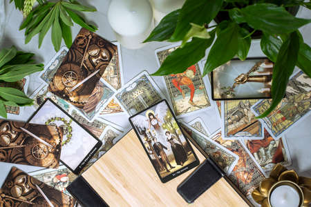 Tarot cards on fortune teller desk. Future reading and esoteric concept. Magic rituals. Mystical table with details. High quality photoのeditorial素材