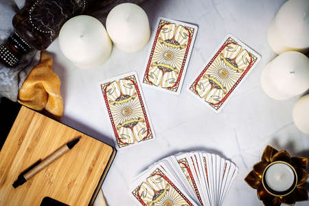 Tarot cards on fortune teller desk. Future reading and esoteric concept. Magic rituals. Mystical table with details. High quality photoのeditorial素材