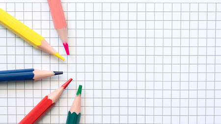 Coloful pencils on the blank checkered page. High quality photoの写真素材