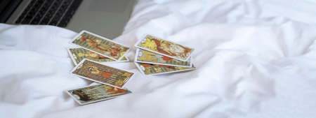 Blurred view of gold tarot cards on the table, esoteric concept, fortune telling and predictions. High quality photoのeditorial素材