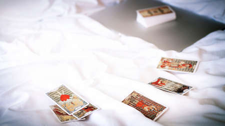 Blurred view of gold tarot cards on the table, esoteric concept, fortune telling and predictions. High quality photoのeditorial素材