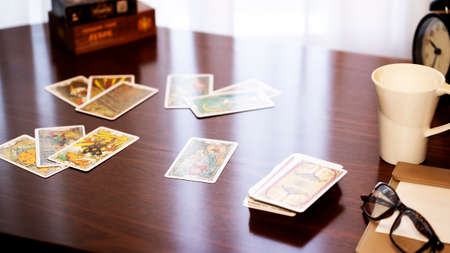Blurred view of tarot card on the table, esoteric concept, fortune telling and predictions. High...