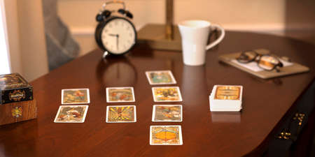 Blurred view of tarot card on the table, esoteric concept, fortune telling and predictions. High...