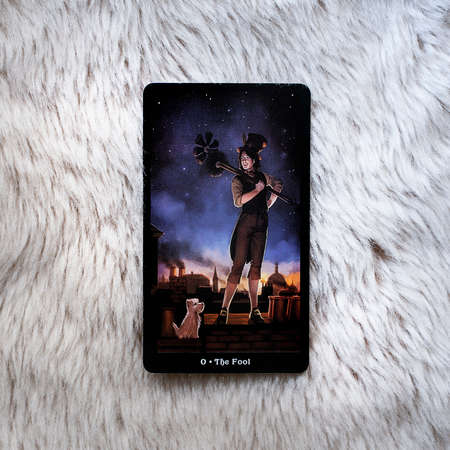 Moscow, Russia - June 2021: Tarot card the Fool on a light beige fur background, esoteric concept, fortune telling and predictionsのeditorial素材