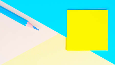 Education concept. Blank Multi colored paper geometric background with Blue pencil and yellow Green...