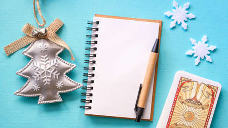 Moscow, Russia - JuLy 2021: Winter composition with Tarot cards and snowflakes on the Blue background, esoteric concept, fortune telling and predictionsのeditorial素材
