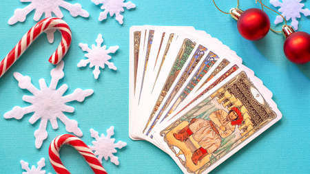 Moscow, Russia - JuLy 2021: Winter Christmas composition with Tarot cards and snowflakes on the Blue background, esoteric concept, fortune telling and predictionsのeditorial素材