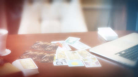 Tarot card reader arranges cards in a card spread. Fortune-telling on traditional tarot cards on the table. Selective focus, Moscow, Russia-June 2021.のeditorial素材